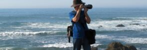 Man taking photo on sea coast